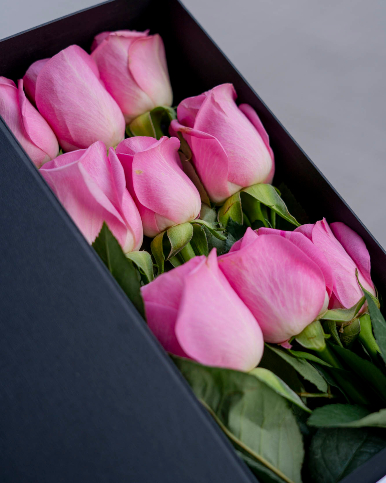 9 pink roses packed in a letter shaped box