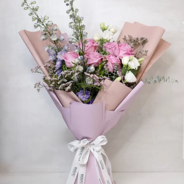 Delphinium Dreams bouquet of pink roses, delphinium, white lisianthus with fillers of pink limonium