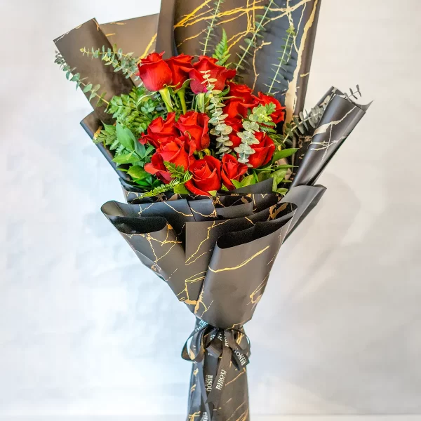 Red Dreaming bouquet of 12 stems of red roses with fillers in a nice special black wrapping