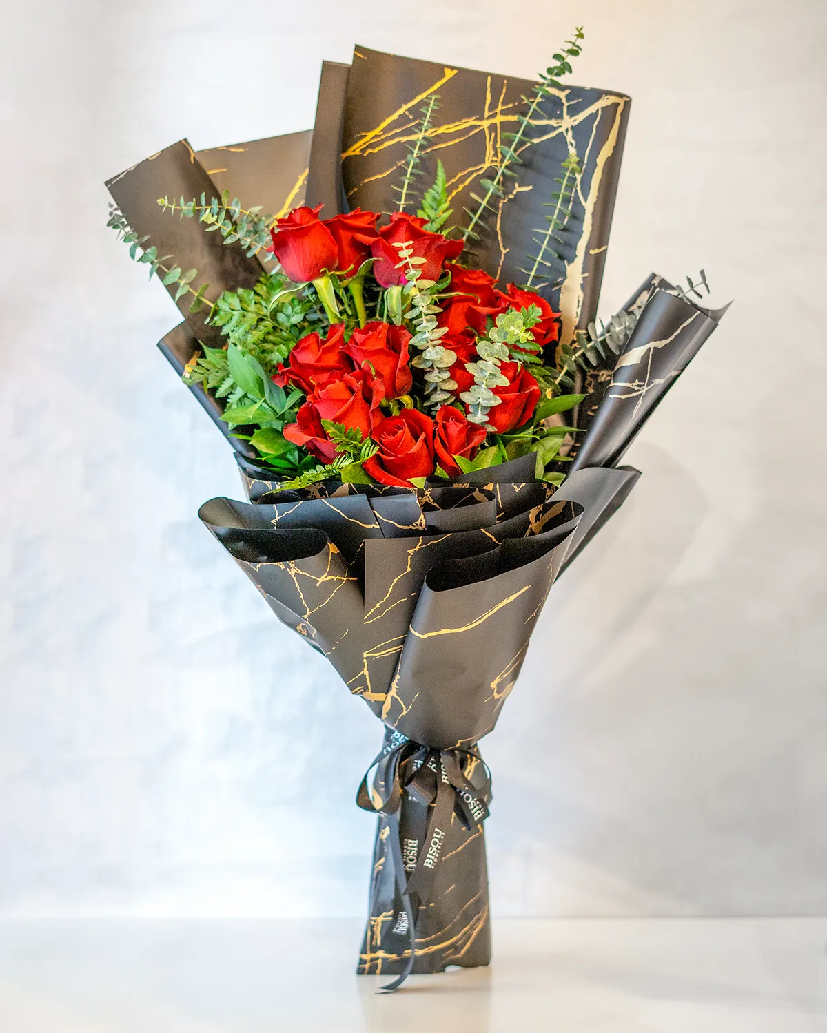 Red Dreaming bouquet of 12 stems of red roses with fillers in a nice special black wrapping