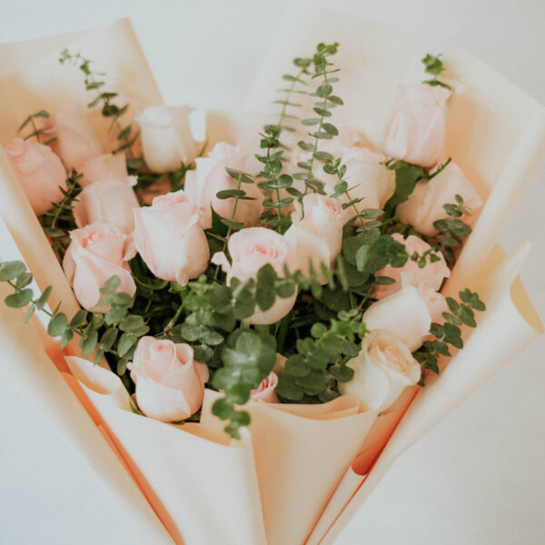 Bouquet of 25 stems of pink roses with fillers in a nice wrapping